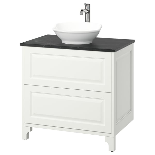 A white TÄNNFORSEN bathroom vanity with dark countertop, round bowl sink, chrome tap, classic design.