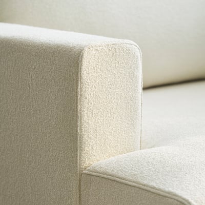 Close-up of UPPÅKRA sofas soft, light-colored cushions, showcasing its high-quality, inviting fabric.