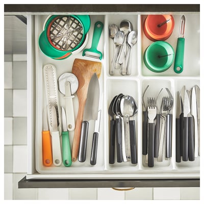 Kitchen drawer with UPPFYLLD fruit cutter set: green, orange, and white tools. Knives, peelers, and cutters organised in sections.