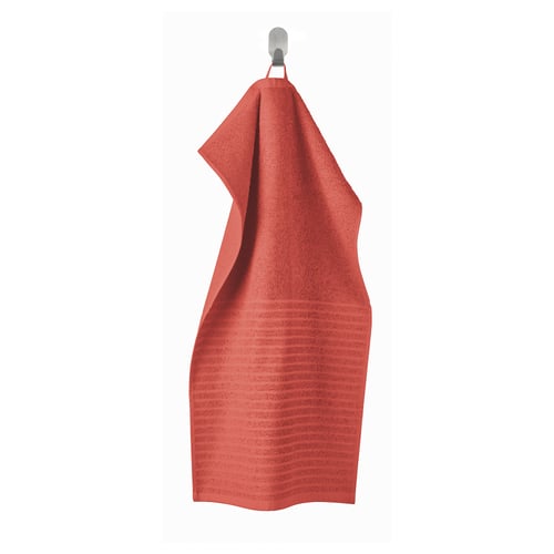 Bright orange VÅGSJÖN towel hangs on hook, striped texture, soft cotton.