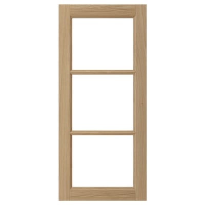 Wooden ikea VEDHAMN cabinet door with natural oak finish, rectangular frame, and two glass panels.