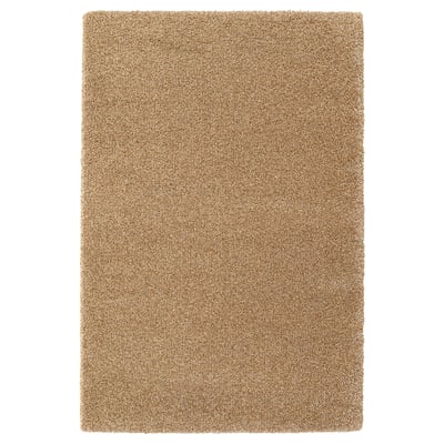 A rectangular brebärare rug in beige, featuring a soft texture and round, short pile made from polypropylene.