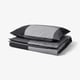Grey BRUNKRISSLA duvet cover, folded with matching pillowcases, cotton and viscose blend, rectangular with stripes.