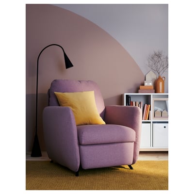 An EKOLSUND pink recliner chair. It has a rounded shape, padded seat and back, with black legs and adjustable backrest.