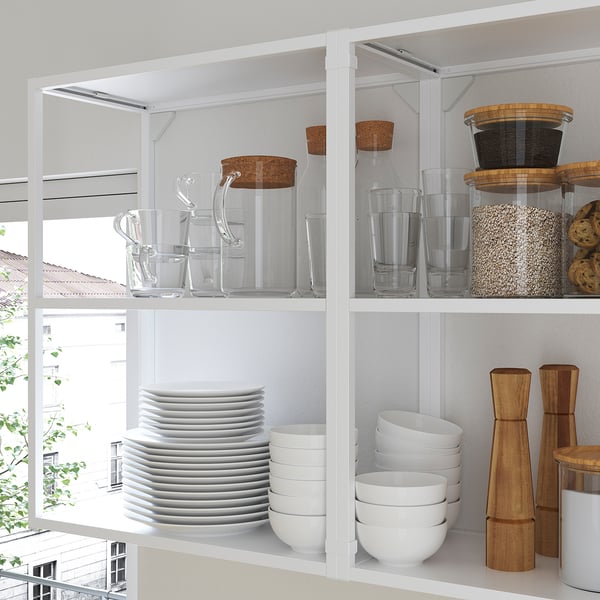 Modern kitchen shelves with glass jars and white dishes, displaying organised storage.
