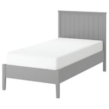 Gullberg grey wooden bed, modern classic design, white mattress, four legs, slatted headboard.