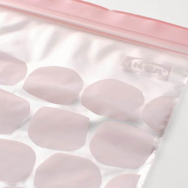 Sealed plastic bag filled with light pink circular ice cubes, ISTAD label visible.