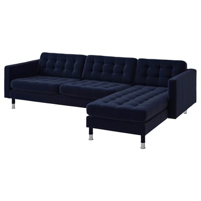 Dark blue, modern l-shaped velvet sofa with chrome legs, tufted seats, and adjustable armrests.