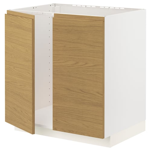 A white METOD kitchen cabinet with light brown oak effect doors, featuring a minimalist and modern design.
