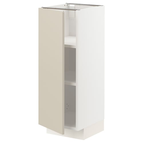 A white METOD kitchen cabinet with beige door and shelves. The cabinet has a rectangular shape and smooth, clean design.