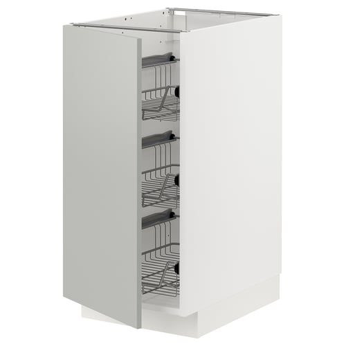 This image shows a white METOD kitchen cabinet with wire baskets inside. It multiple shelves for storage and an open door, displaying its interior.