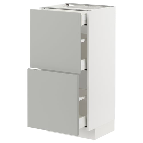 This image shows a white and light grey ikea METOD kitchen cabinet with two drawers and a door in a minimalist design with a clean look.