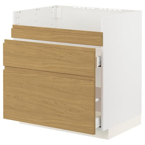 An ikea METOD kitchen cabinet in white and oak. It has integrated handles and is part of the voxtorp series.