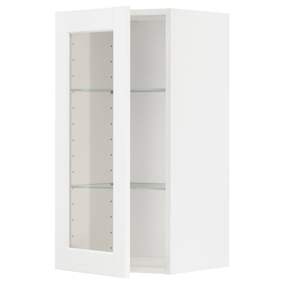 A white METOD kitchen cabinet with glass doors and adjustable shelves.