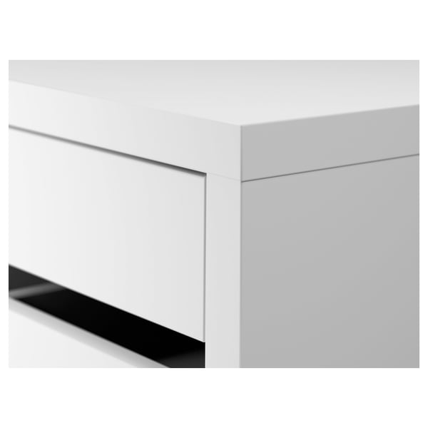 Close-up of sleek, modern white desk corner. Smooth edges, glossy top, and clean lines.