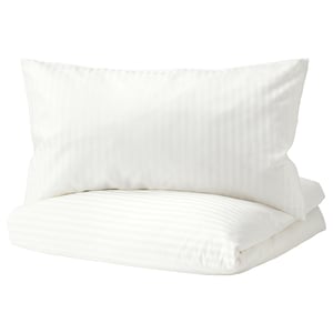 White duvet cover set with subtle stripes, made from cotton and lyocell, neatly folded.