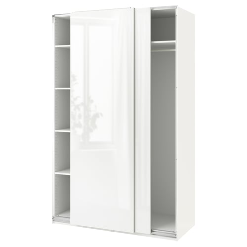 A white ikea PAX wardrobe with sliding doors and clear shelves.