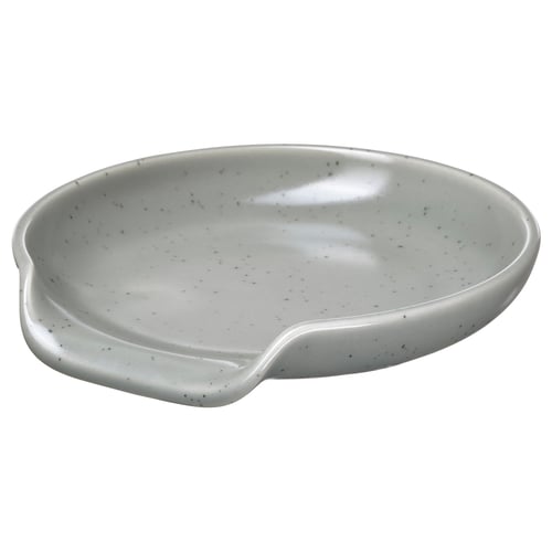 White RÖDSYRA ceramic spoon rest with dotty glaze, oval shape, ergonomic handle.