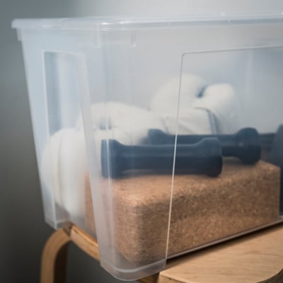 Clear plastic storage box, square shape, transparent sides, lid with click lock, used for organising items.