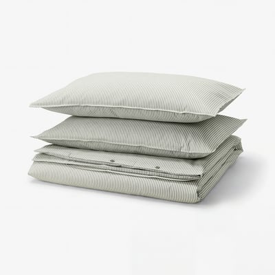 A stack of green and white striped SOLFIBBLA cotton duvet covers.