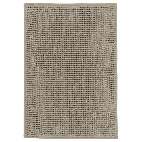 Rectangular grey bath mat, textured with raised dots, soft and quick-drying.