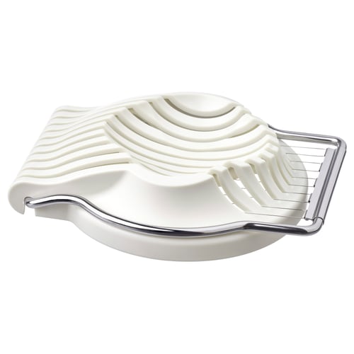 White egg slicer, metallic handle, curved shape, textured grip.