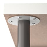 A close-up of a modern table base with a metallic pole and screws for stability.