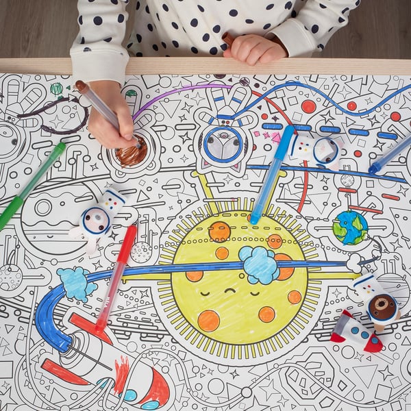 Child coloring a large space-themed coloring sheet with multiple pens.