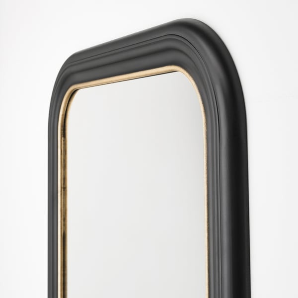 Elegant ALMARÖD mirror with black frame edged in gold, reflecting high-quality craftsmanship.