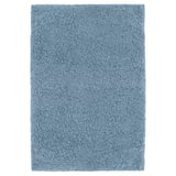 A blue IKEA ALMTJÄRN bath mat, rectangular and soft, made from recycled polyester, offering comfort and absorbency.