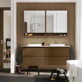 Modern bathroom: brown cabinet, 2 sinks, mirrors, black stool, towels. Minimalist design.