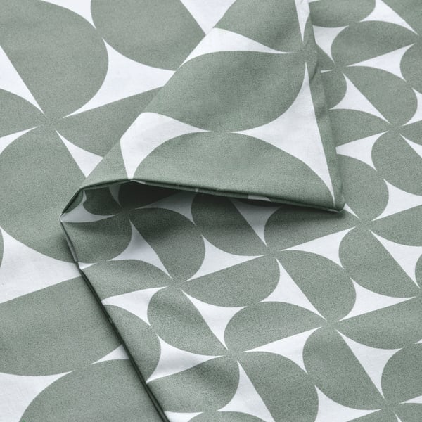 Fabric with repeating geometric patterns in muted green and white. High-quality, crisp texture visible.