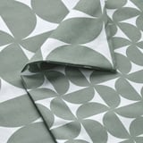 Fabric with repeating geometric patterns in muted green and white. High-quality, crisp texture visible.