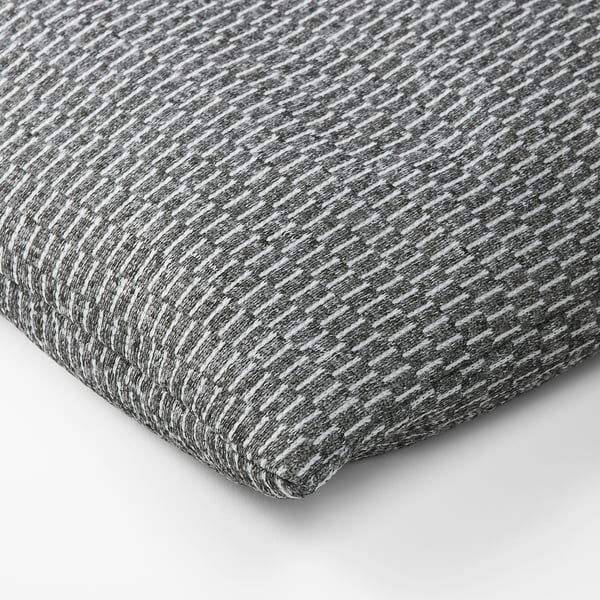 A textured, gray and white fabric, likely from a heating or cooling pad, displaying a soft, woven pattern
