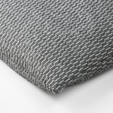 A textured, gray and white fabric, likely from a heating or cooling pad, displaying a soft, woven pattern
