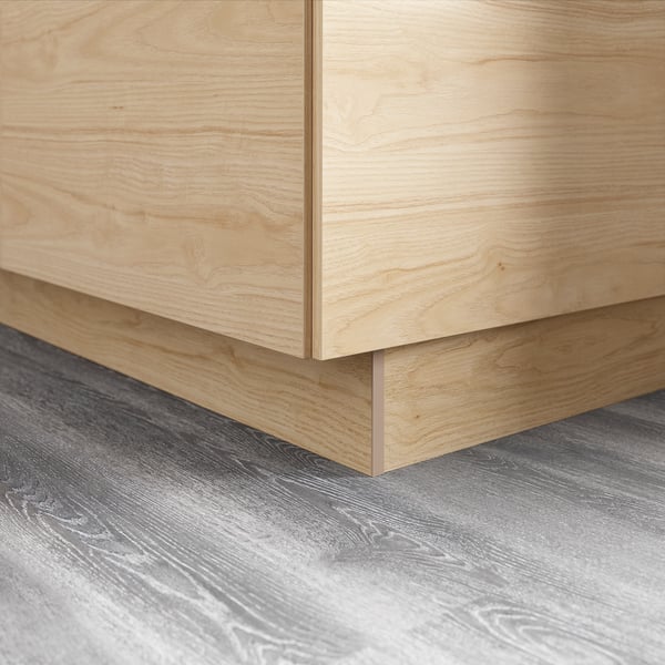 Wooden cabinet leg, light ash finish, melamine surface.