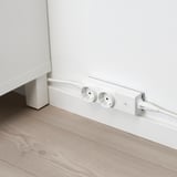 White wall socket with two plug adapters and a cable, part of the ÅSKVÄDER series for flexible power solutions.