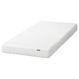 An IKEA ASPSJÖKULLEN white foam mattress. It is rectangular, with a smooth, quilted white cover, and is designed for comfort.
