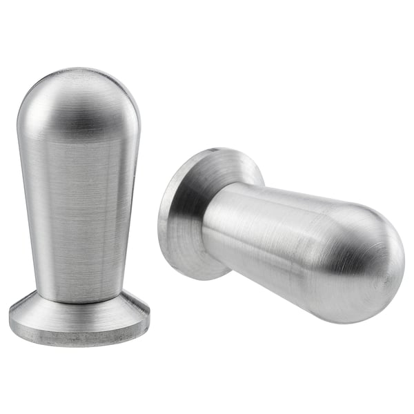 Two stainless steel BAGGANÄS knobs; one round with a flat base, the other cylindrical with a smooth finish. Modern, minimalist design.