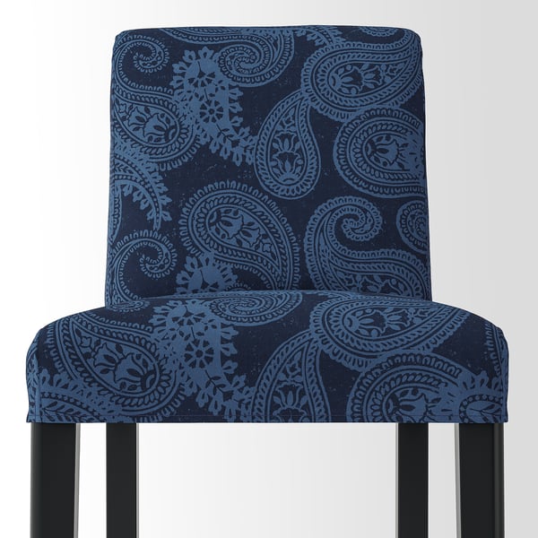 Blue paisley-patterned bar stool with wooden legs. Comfortable, durable design, featuring a machine-washable cover.