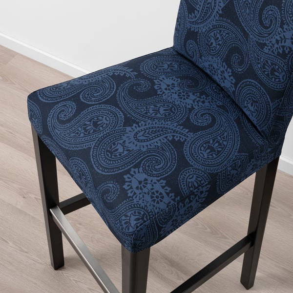 Elegant bar stool with intricate paisley pattern in deep blue. Upholstered for comfort, featuring sturdy wooden legs and supportive backrest.