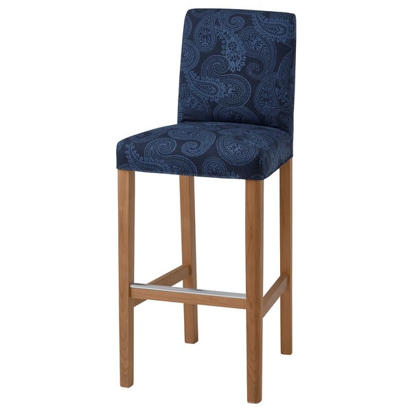The BERGMUND barstool a navy paisley seat, wooden legs, and a high back for comfort.