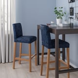 Two blue paisley BERGMUND stools at dark wood counter with plant and jars.