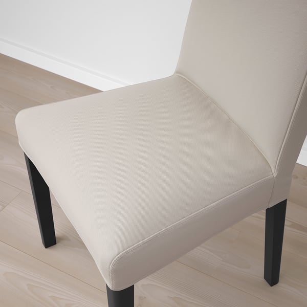 Neutral-toned modern chair with sleek black legs, showcasing high-quality upholstery and contemporary design.
