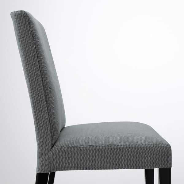 A modern upholstered chair with high back and wooden legs. Its designed for comfort and style.