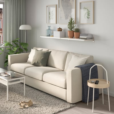 Living room with shelf, sofa, and decor.