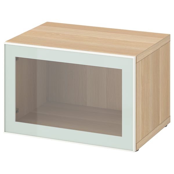 Light wood BESTÅ storage unit with glass door.