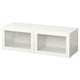 A white BESTÅ storage unit with glass doors. It a rectangular shape and sleek design.
