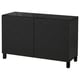Black BESTÅ cabinet with textured doors and glass top.