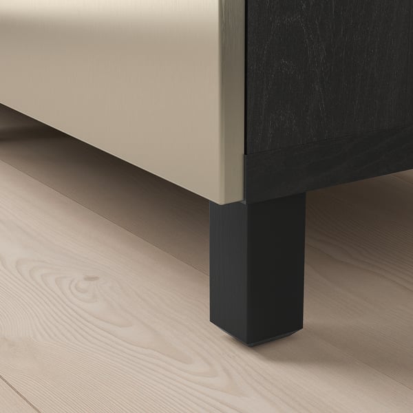 Close-up of modern storage unit: sleek beige exterior, dark legs, polished wood floor.